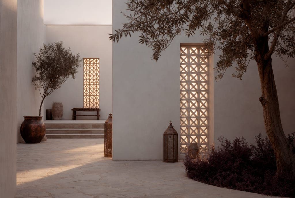 A whitewashed courtyard with geometric lattice screens at dawn
